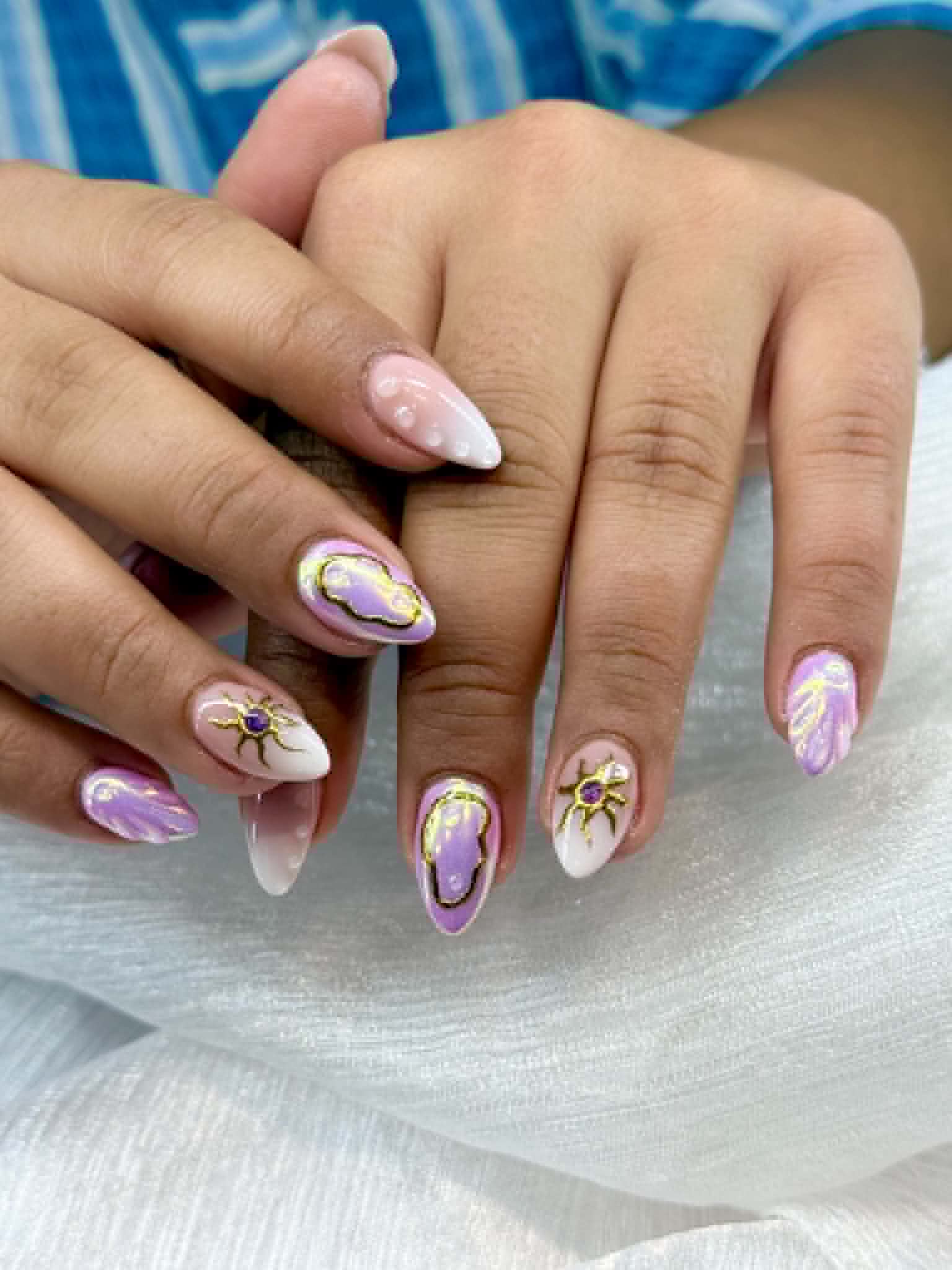 Purple and gold hand-painted nail art